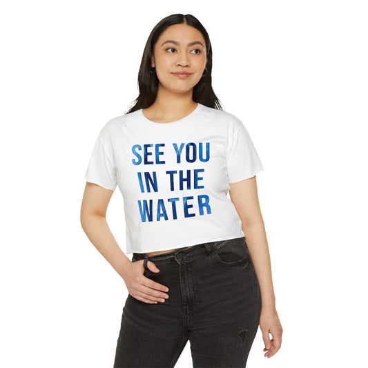 Person wearing a white t-shirt with 'SEE YOU IN THE WATER' text on a white background